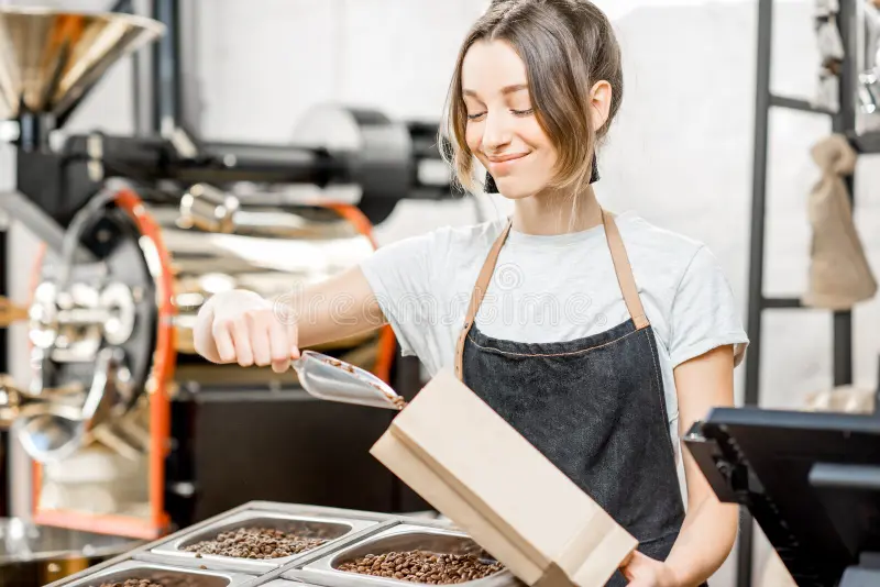 young-women-seller-uniform-filling-bag-coffee-beans-working-store-shop-113365115